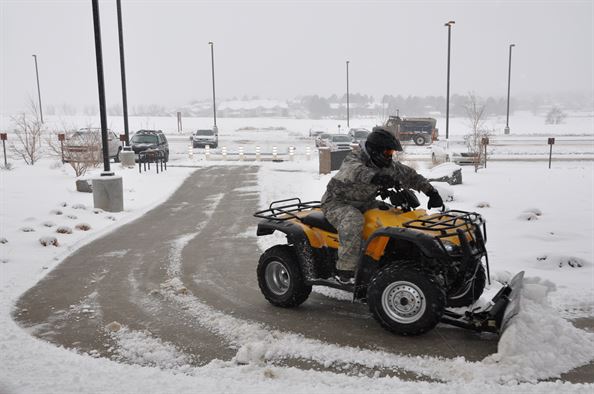 ATV Snowplow clearing parking lot
